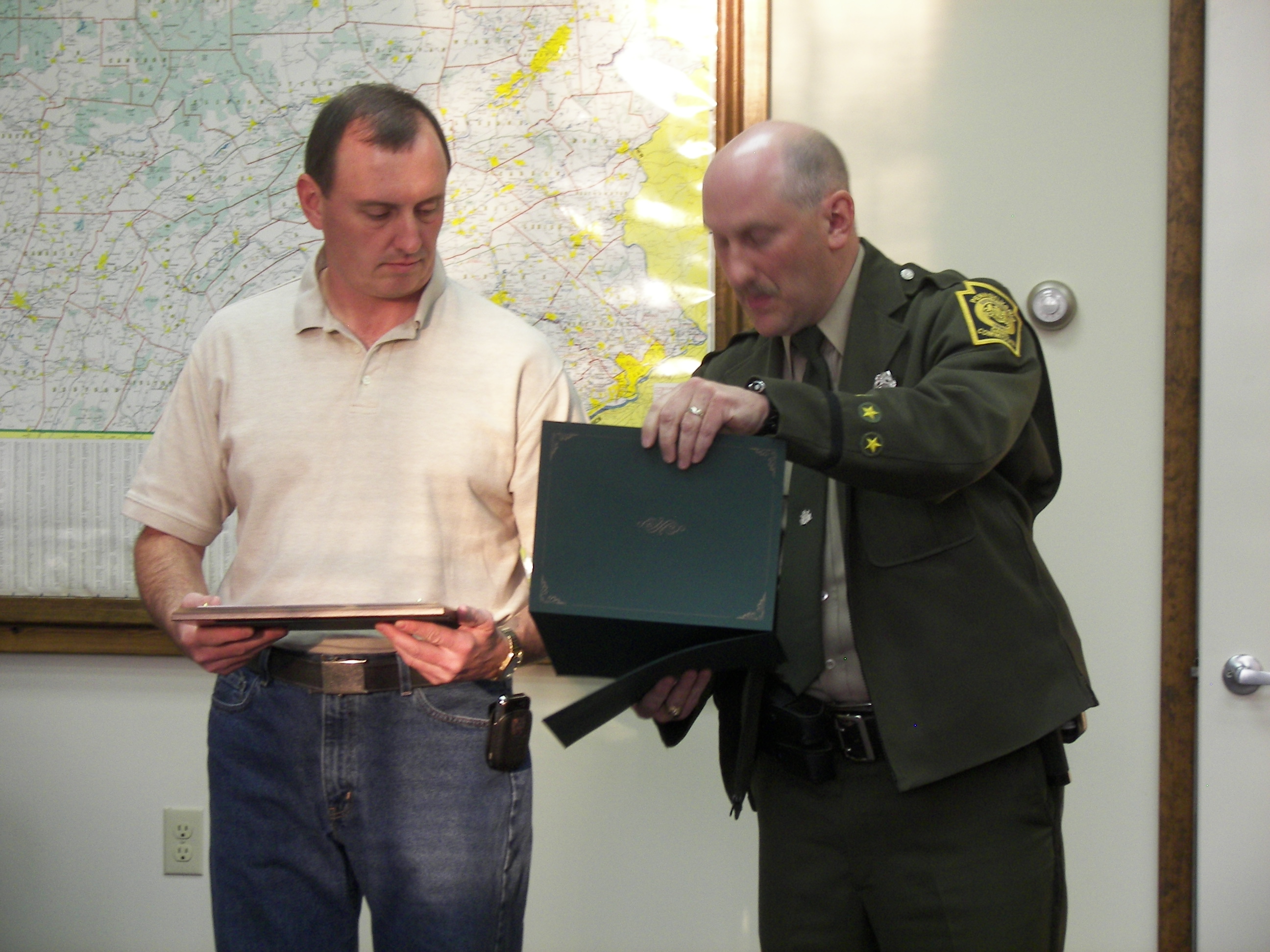 Jeff Rhone, Chief of Police, receives an award from David Carlini of the Pennsylvania Game Commission