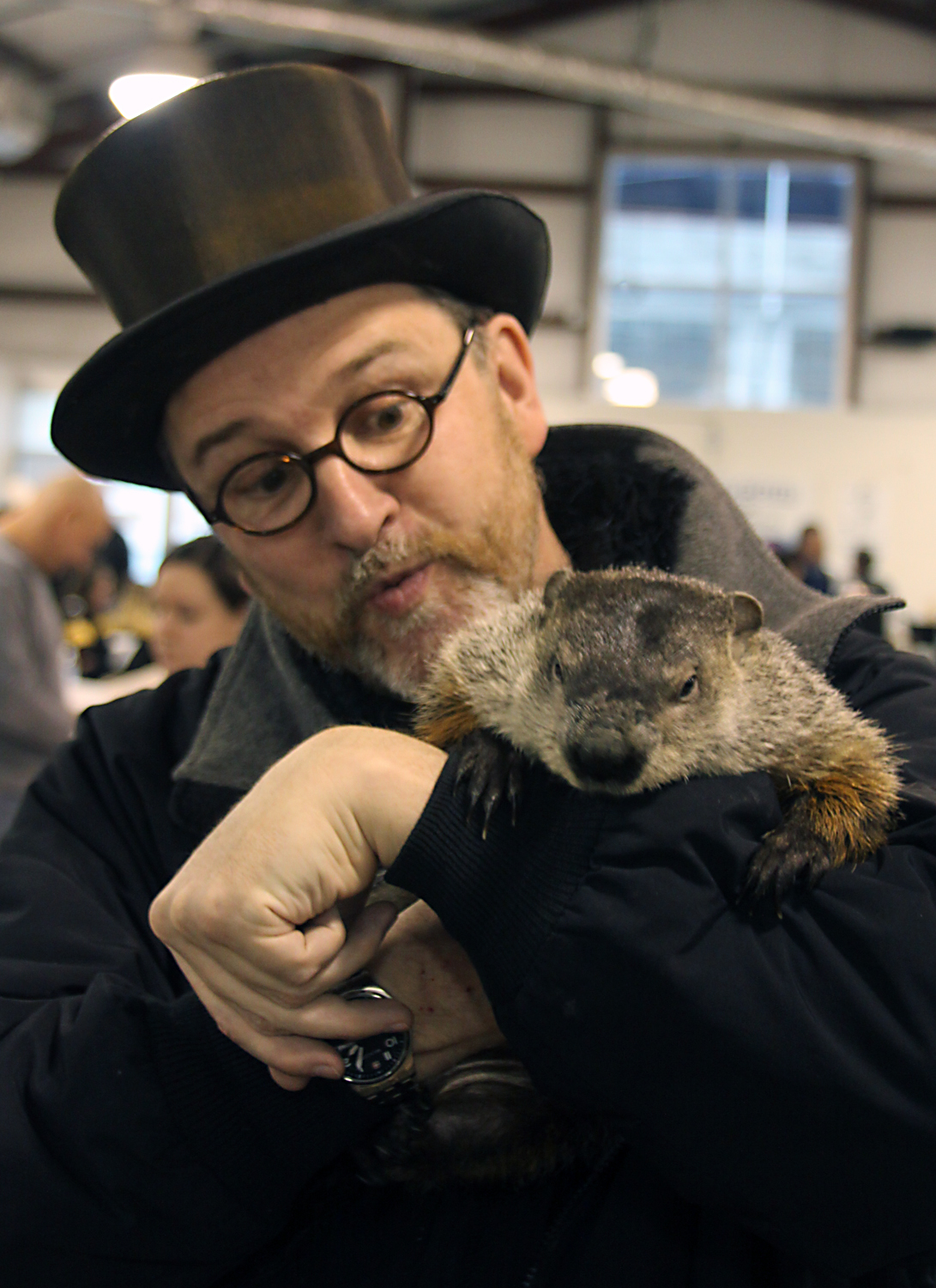 Ben Hughes, Phil's handler, holds the groundhog up for a photo before taking a break.