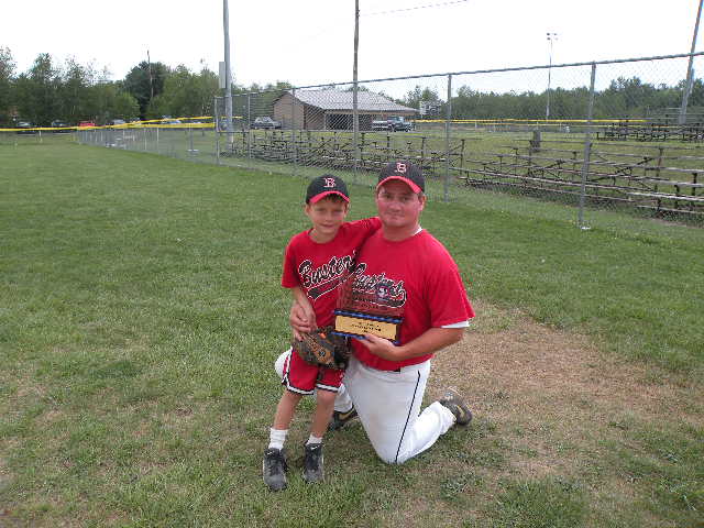 Manager Brian Barr with championship trophy and big fan Nolan Barr.