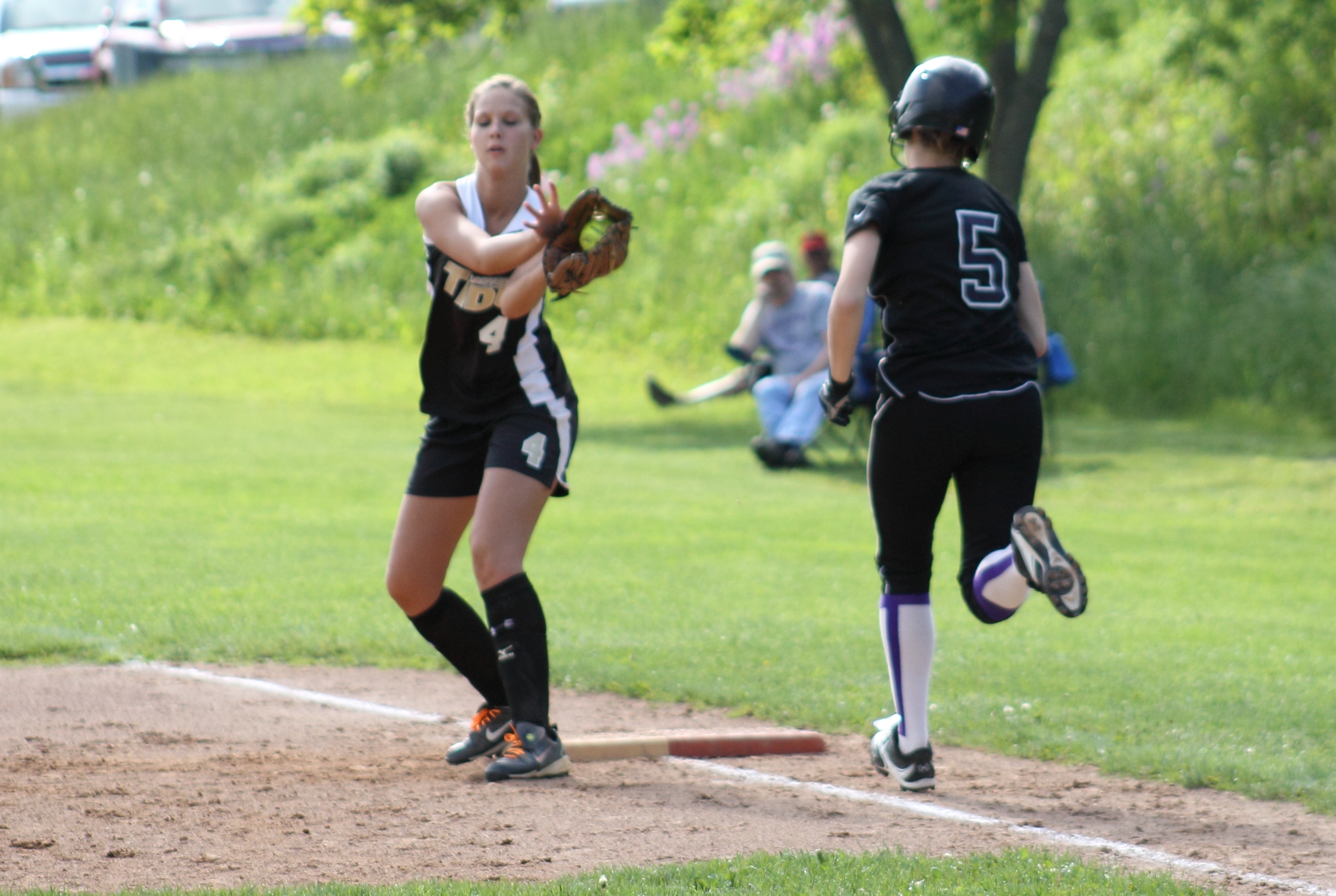 Lady Tide senior Madi Peterman pulls in a throw at first to erase Coudersport's Kayla Ness in District IX play-off action. Coudersport went on to eliminate Curwensville 8-5.  (Photo by Rusty McCracken)