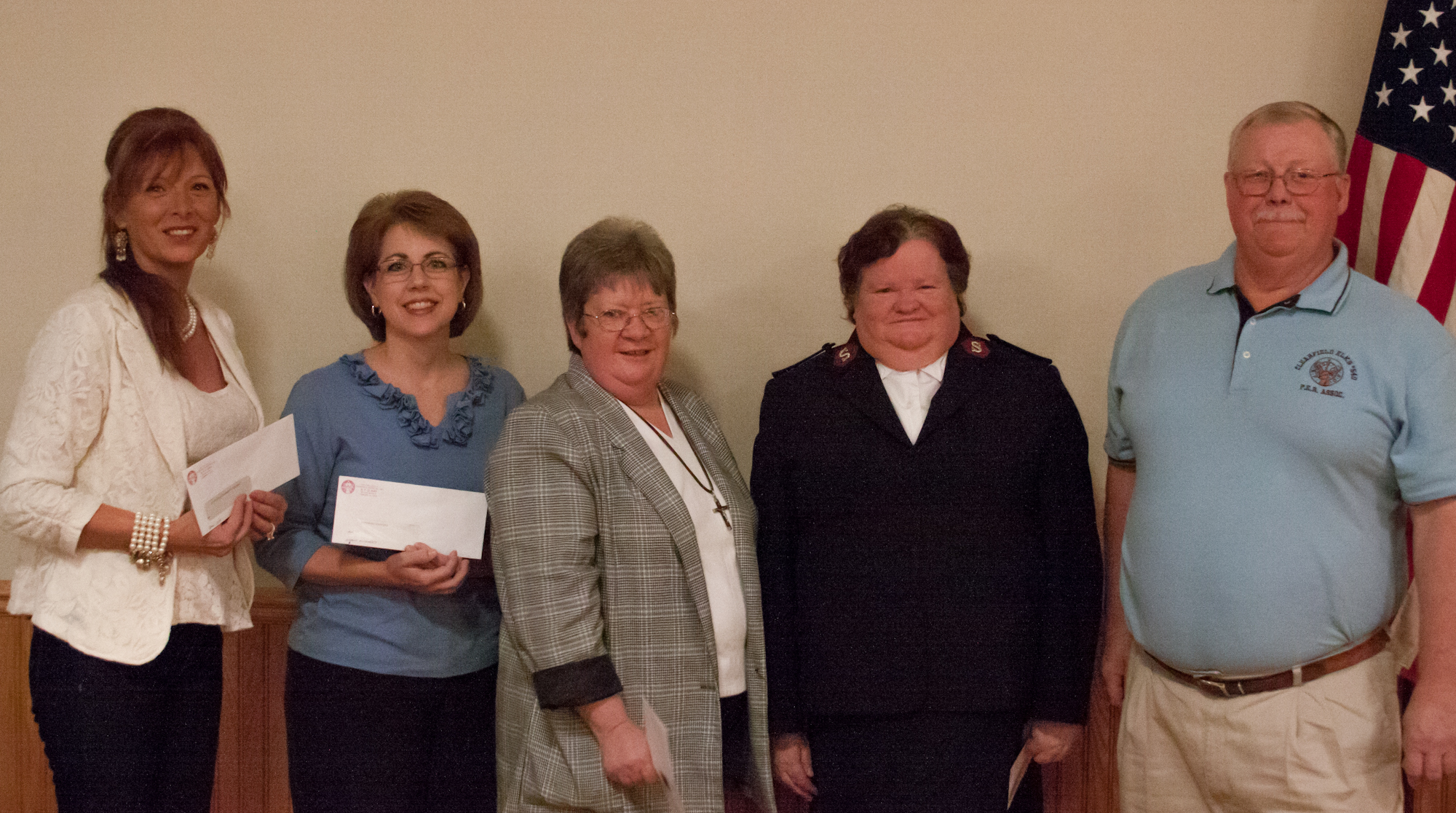 Pictured are organization representatives that received donations. From left to right, the reps are from Elks Christmas Parade, CAHS Music Boosters, Marian House, Salvation Army and the Elks' presenter Denny Flanagan.