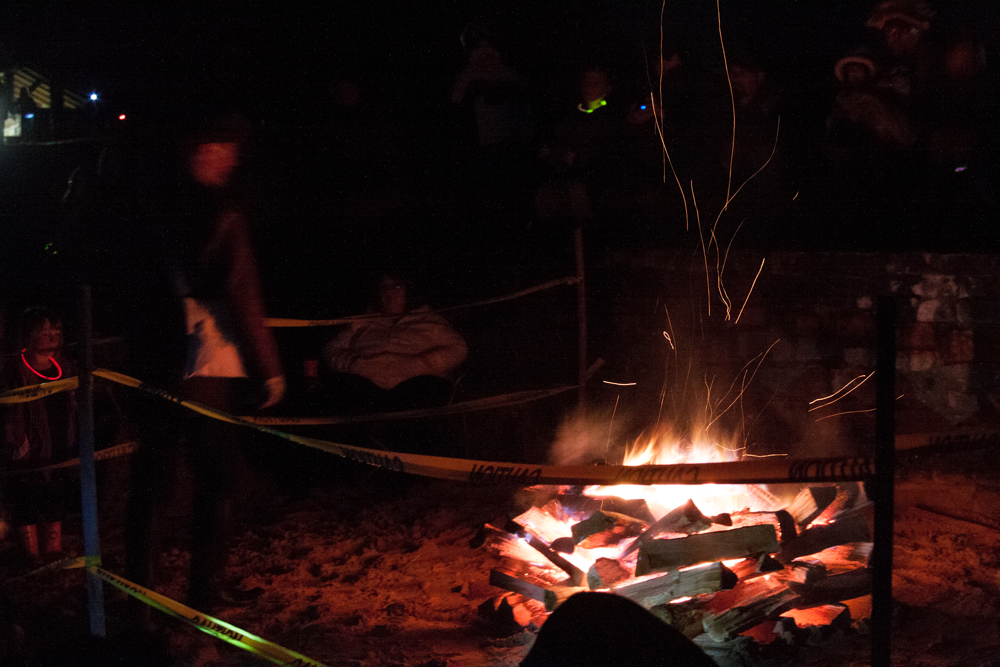 Huber stands at the bonfire and tells historical tales.
