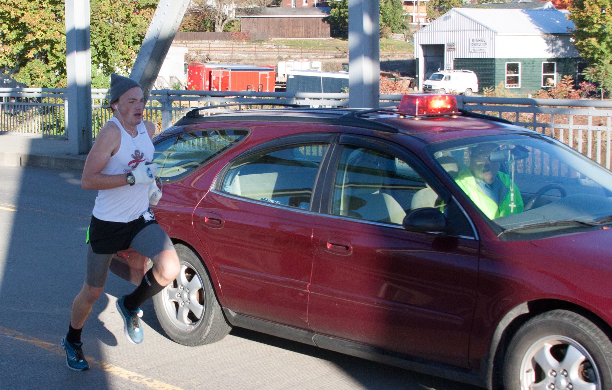 Clearfield Mayor James P. Schell stops as the course ends.  He led the path for the run. The fastest runner passes him by.