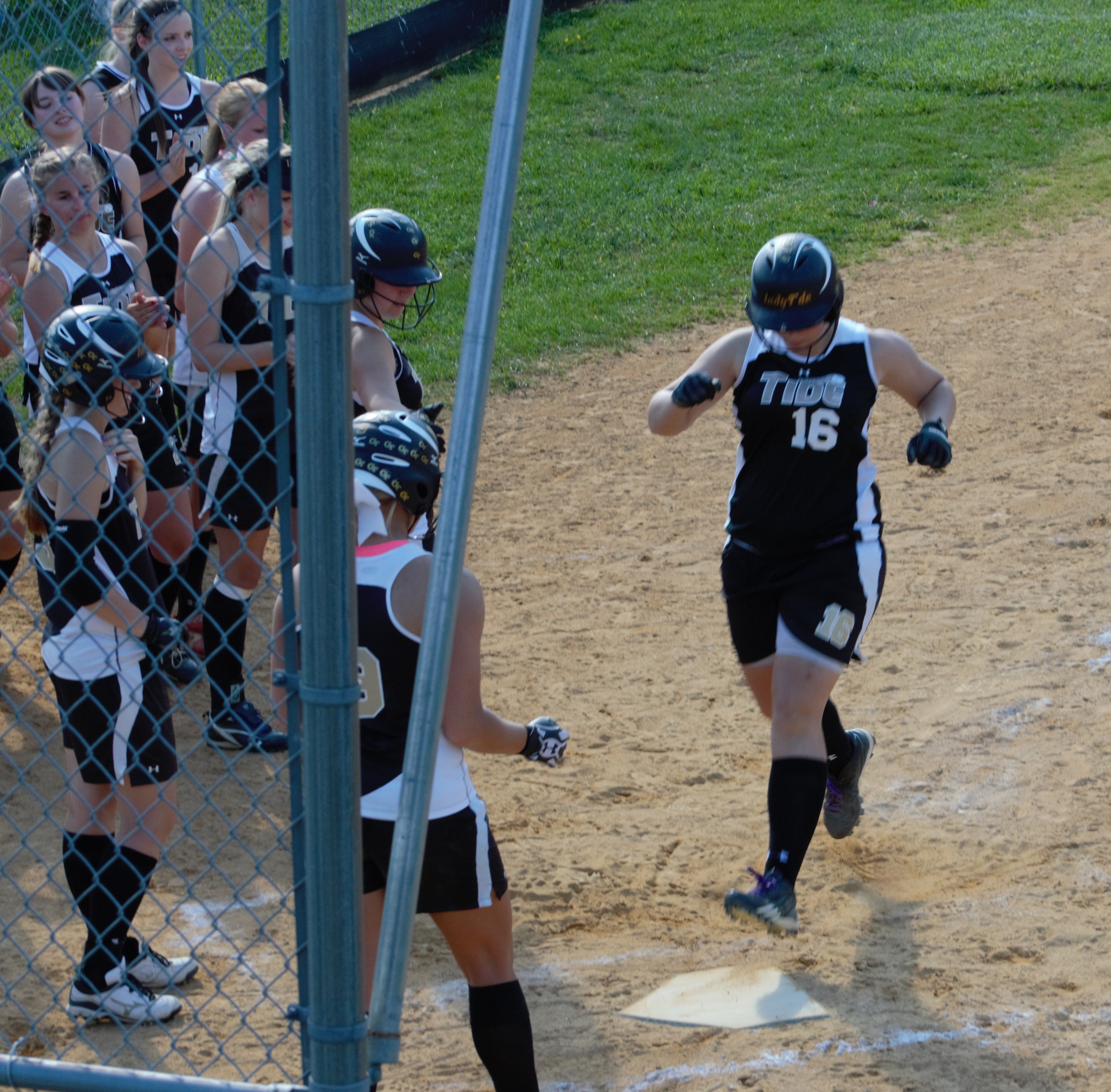 COMING HOME - Curwensville senior Tifany Carter gets a warm reception at home after a three-run homer in the sixth inning.  Curwensville defeated Moshannon Valley 11-2 to Claim the 2013 MVL Title (photo by Rusty McCracken)