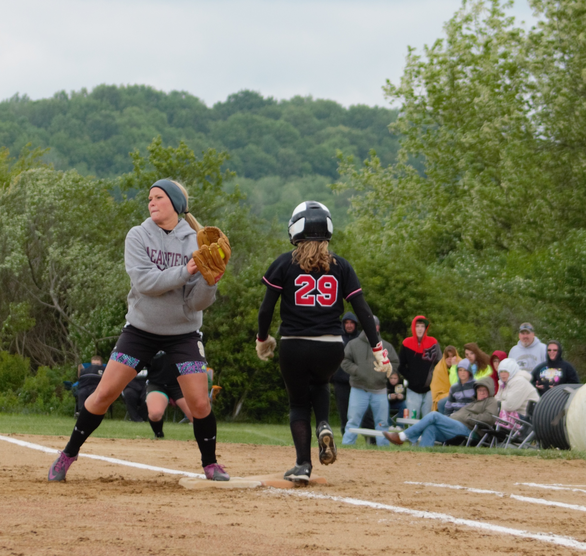 Curwensville second-baseman Taylor Goodman covers first on a bunt attempt by Moniteau's Emily Hiwiller.  The Lady Tide  advanced to the District IX Championship game with a 12-0 win.