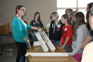 Kiya Riverman, a Penn State graduate student and volunteer instructor for Math Options, introduces seventh grade girls to glacial drift using models.  (Provided photo)