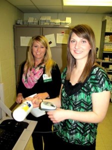 Working to reduce medication errors – Michelle Bennett, PharmD, director of Clearfield Hospital’s Pharmacy, left, and Kira Stottish, PharmD, demonstrate bar-coding technology, which is one of the strategies the hospital uses to reduce medication errors. (Provided photo)