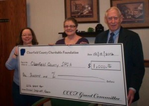 Robert M. Kurtz, Jr., Clearfield County Charitable Foundation Board Member, right, and Julie Rickard, Administrative Assistant for the CCCF, left, present a $1,000 check to Pam Smith, president of the Clearfield County SPCA, to help the organization complete the animal control room in the new SPCA building in Lawrence Township. (Provided photo)