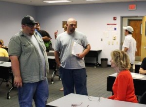 Floor Hand Program graduates Richard Irvin, standing at left, and Anthony Kurtz, speak about job opportunities with Sue Galbraith, a job developer with the North Central Workforce Investment Board.  (Provided photo) 