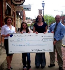 Rex L. Lettie, Clearfield County Charitable Foundation board member, right, presents a $500 check to Keely Casteel, president of the CRC, left, and Kellie Swales, second from right, Main Street Manager to help fund the CRC’s 2013 Fall Festival. Also pictured is Gretchen Yeager, second from left, a student who helped prepare the grant application. (Provided photo)