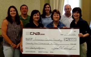 Pictured are Mandi Billotte of the American Cancer Society; Joe Bower, president and chief executive officer of CNB Bank; and CNB Charity Golf Committee Members Carolyn Smeal, Amy Potter, Missy Patterson, Greg Dixon and Eileen Ryan. (Provided photo)