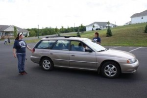 During last year's Car Fit event, students Colleen Prechtl, at the rear of the car, and Anita Johnston work with a driver to assure their mirrors are properly adjusted and provide maximum visibility. (Provided photo) 