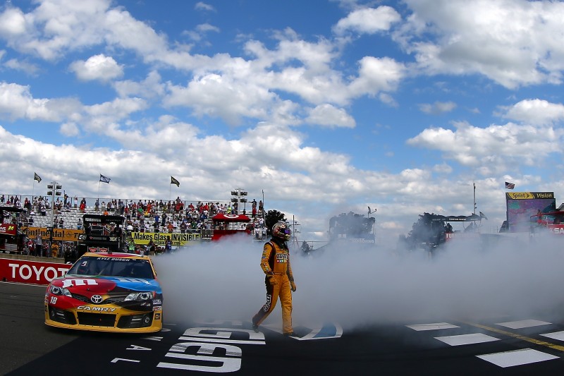 It appeared as though Marcos Ambrose would be celebrating at the end of Sunday's race at Watkins Glen.  But, in the end it was his closest challenger, Kyle Busch, that did the victory burnout.
