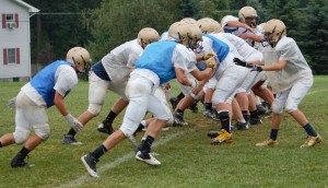 TIDE RUSH - Curwensville's football squad works on blocking schemes for extra-points in the pre-season.  (photo by Rusty McCracken)