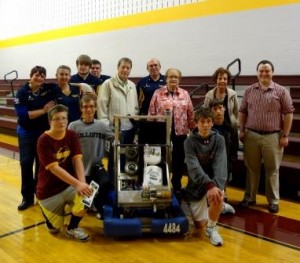 Pictured, kneeling from left to right, are Joshua Scileski, Alan Brennan, 2013 Deadlox Robot, The LOXsmith, Joseph Messineo and Joel Brennan, who are all students at Elk County Catholic.   Standing, in back from left to right, are Crystal Rishell, Deadlox mentor, Jessica Szejk, Deadlox team member, Andrew Wells, Deadlox team member, Padon Rishell, Deadlox team member, CJ Kogovsek, ECCSS board of directors, Dave Rishell, Deadlox mentor, Mary Agnes Marshall, ECCSS president, Sandy Florig, ECCSS principal and Dane Peterson, ECCSS computer technician. (Provided photo) 