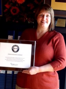 Jackie Syktich, president/chief executive officer of DuBois Business College, is shown holding a plaque honoring the school’s most recent distinction, being named as a Military Friendly School for 2014. (Provided photo)