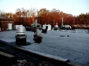 Pictured is Kenneth (Jake) Colpetzer of the Tyrone Hospital Maintenance Department looking at a completed section of the new roof currently being installed at Tyrone Hospital.  (Provided photo)