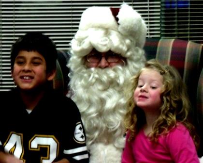 Santa Claus visits with Denis and Elli Swales and informs them that they made his nice list this year. (Provided photo)