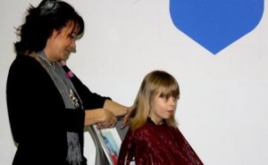 Six-year-old Adell Doty volunteered to have her hair cut by stylist Brenda McGarvey for the THON Hair Auction.  Doty also plans to donate the 10 inches of her hair that was cut to Locks of Love, to be made into wig for a cancer patient.  (Provided photo)