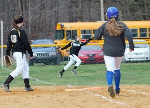 Senior Melanie Milliron covers ground in right field to make a key catch in the Lady Tide's 8-7 victory over Johbnsonburg on Wednesday.  Teamate Kikki Harker watches the play whie Rammette Ashton Watts is put out.  Photo by Rusty McCracken