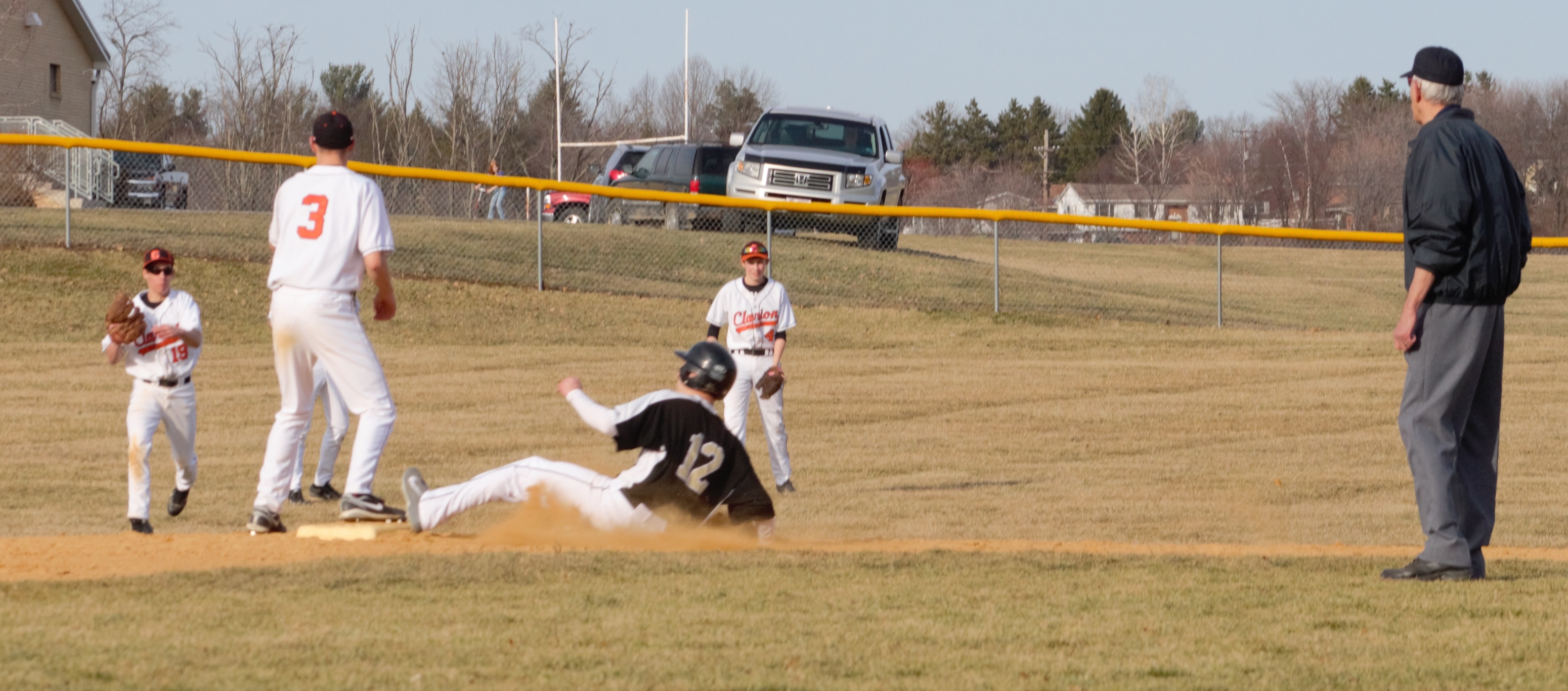 DRAWING A CROWD -Curwensville Senior Tanner Elensky slides safely into second base after a pop-up single by  Travis Lansberry as several Clarion players converge on the play.  Clarion bested Curwensville 10-0 in favie innings yesterday afternoon.  (photo by Rusty McCracken)