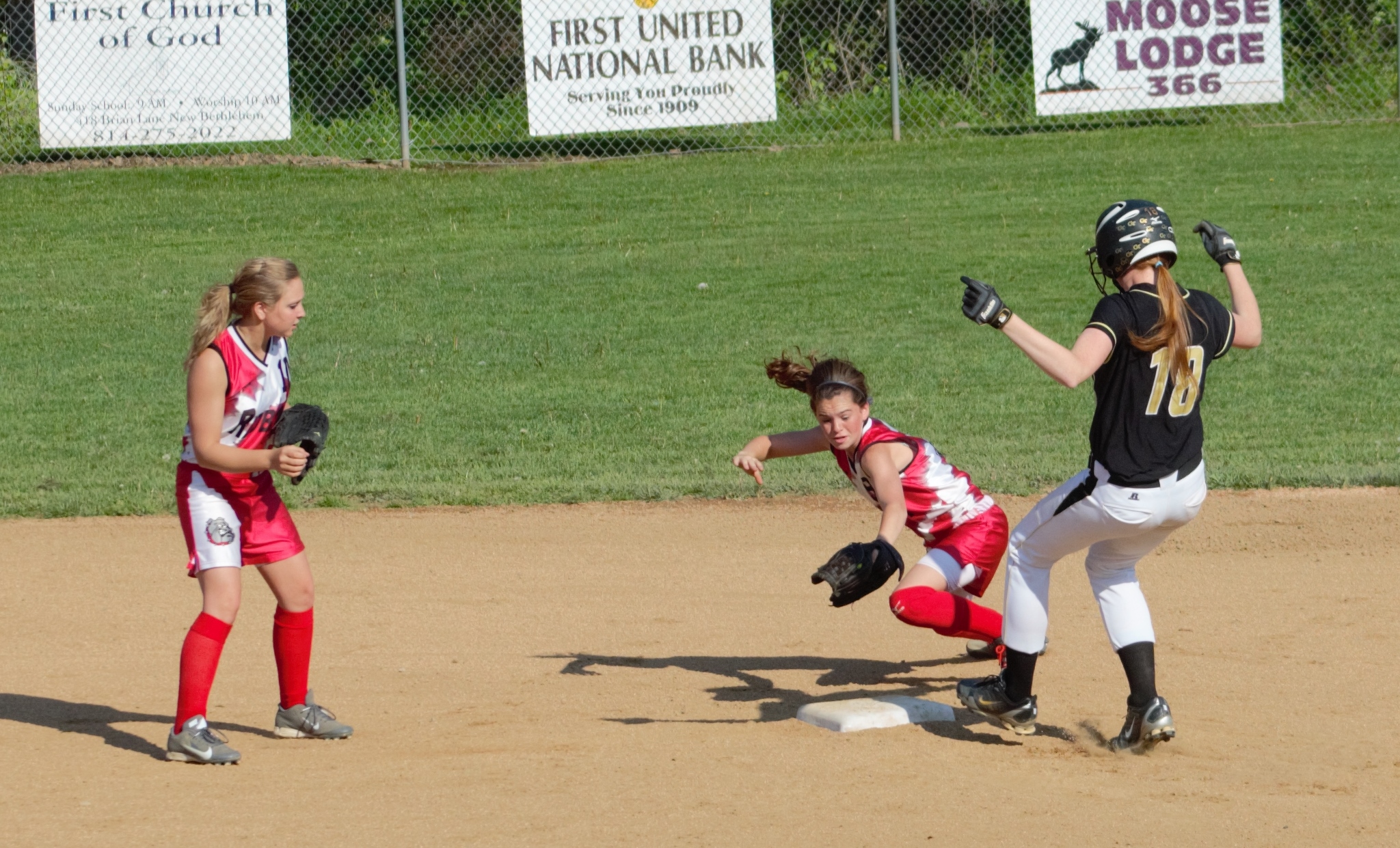 Senior designated player Kealy Wassil pulls into second after one of her three hits against Redbank Valley in a 13-3 District IX Class AA quarterfinal win.  Wassil scampered into second when her hit to center was misplayed.  Bullgog second baseman Mackenzie Pence tries to apply the late tag while teammate Kimberly Shick backs up the play.  (photo by Rusty McCracken)