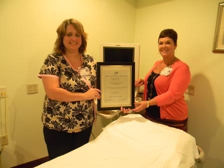 Lisa Redmond, lead ultrasound sonographer (left), and Women’s Center manager, Lisa Housler, display an award received for excellence in ultrasound-guided breast biopsies.  (Provided photo)