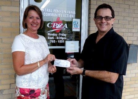 Denny Liegey of Denny’s Beer Barrel Pub is pictured presenting the $1,000 check to Connie Harris, Clearfield County Family Services supervisor with the CPCA. (Provided photo)