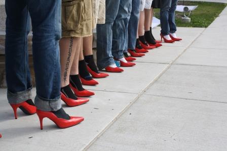 Men lined up in their red high heels during last year's Walk a Mile in Her Shoes. (Provided photo)