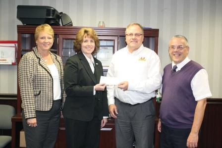 Pictured, from left to right, are Penn State DuBois' Director of Development Jean Wolf and Chancellor Melanie Hatch who accept a check from Phoenix Sintered Metals Chief Operating Officer Steve Leuschel and Community Initiatives Coordinator Nick Hoffman. (Provided photo)