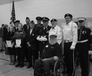 Pictured, in the front, is Jerry "Bull" Baylor, sports director of the Keystone Paralyzed Veterans of America. From left in the next row are students Caroline Baker and Michaela Herndon; Tom Weaver of Post 392 American Legion; Denny Knarr, Richard Trudgen, Anthony Waylonis and Richard Wantuck, all Honor Guard members. In the back row, from left, are Michael Skehan, Honor Guard member, John Kuntz of Post 392 American Legion and Joseph Volansky, Honor Guard member. (Provided photo)