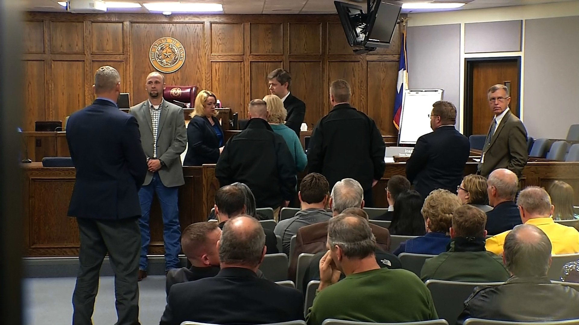 People stand inside the courtroom in Stephenville, Texas, on Feb. 24, 2015, where a jury delivered a guilty verdict against Eddie Ray Routh, the man who killed Chris Kyle and Chad Littlefield. Kyle gained notoriety following the release of "American Sniper," detailing his time in Iraq. (POOL)