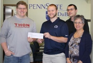 Pictured from left are Greg Myers of the Penn State THON Committee who accepts a check from Business Society members Ray Serafini and Nathanial Assalone, and faculty advisor Annette Muth. (Provided photo)