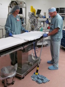 Highmark recently recognized Penn Highlands Clearfield for adherence to patient safety practices and preventing hospital-acquired conditions. An important part of ensuring a safe environment is keeping the facility clean and sterile. Here, Tracy Twigg, registered nurse, changes linens while Lester Mann of environmental services cleans the floor of one of the hospital’s operating rooms. (Provided photo)  