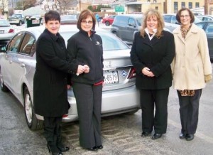 Shown, from left, are Michele Fannin, auxiliary president, handing the Civic keys to Kathy Gillespie, CCAAA Inc. chief executive officer.  Also present were Vicki Myers, auxiliary treasurer, and Ranea Brewer, auxiliary vice president. The auxiliary provided the remaining funds not covered by the AFIG grant to purchase the Honda Civic. (Provided photo)
