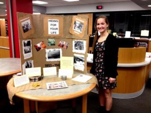 Ninth grade English student, Erica Hanes, is pictured with her Holocaust research display at the library at the Clearfield Area Junior-Senior High School. (Photo by Jessica Shirey)