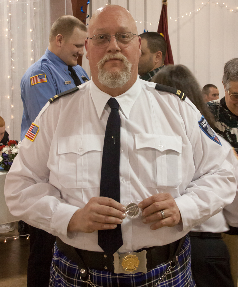 Fire Department Chaplain James Whited is pictured with his coin.
