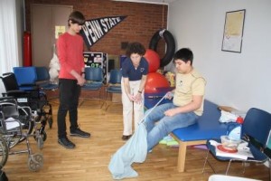 Instructor in the Occupational Therapy Assistant Program LuAnn Demi demonstrates techniques for helping patients dress themselves to students Alan Weible of Brockway (seated) and Donavan Hoffman of Brookville.  (Provided photo)