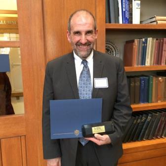 Robert Loeb is shown with his 2015 John Romano Faculty/Staff Diversity Recognition Award. (Provided photo)