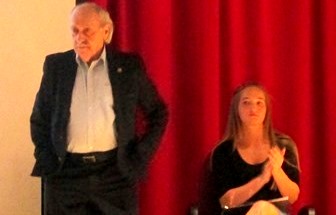 Auschwitz Concentration Camp survivor David Tuck stands during a recent assembly at the Clearfield Area Junior-Senior High School. Seated is Erica Hanes, whose interview with Tuck for her ninth-grade research project about the Holocaust led to his visit to the school.  (Photo by Anna Brower)