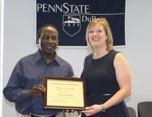 Assistant Professor of Engineering Daudi Waryoba receives the Educator of the Year Award from DEF President Carrie Wood. (Provided photo) 