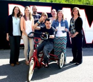 Brandon Druzak sits on a bike identical to the one he will soon have at home. Behind him, left to right, are: Nicole Braun, multi-disabled support teacher at DAHS; Daniel Hodgdon, Penn State OTA student; Steven Druzak, Brandon's father; PSU OTA students Katie Armagost, Hannah Schatz, and Brittany Auman; and OTA instructor Amy Fatula. (Provided photo)