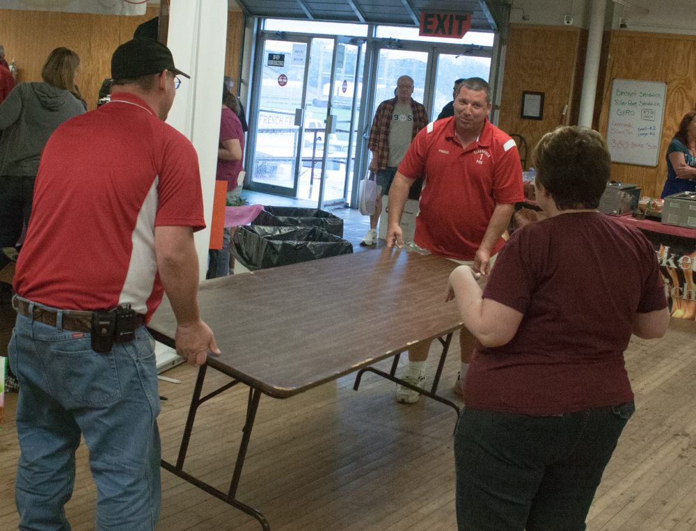 Volunteers reorganize some of the floor space to give people a place to sit down.