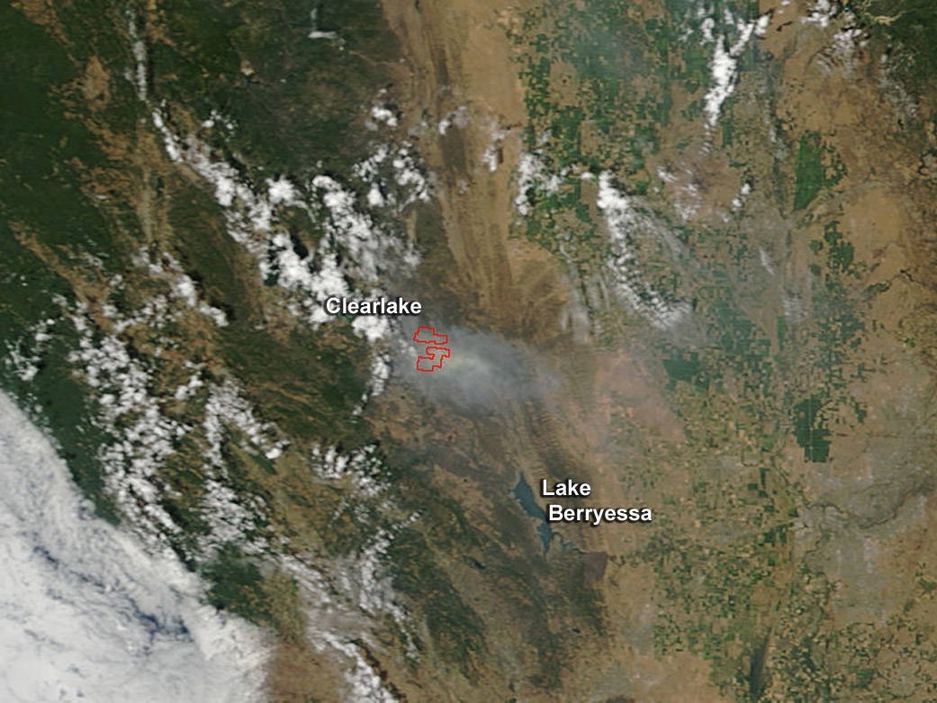 Caption: The Rocky Fire in Lake County, California, is generating enough smoke to be seen from space on July 31, 2015. The fire is located in Lower Lake, about 30 miles north of Santa Rosa. The Moderate Resolution Imaging Spectroradiometer (MODIS) instrument that flies aboard NASA's Terra satellite captured an image of smoke from the Rocky Fire near Clearlake, California, on July 30, 2015, at 18:45 UTC (2:45 p.m. EDT). The multiple red pixels are heat signatures (red) detected by MODIS. The smoke appears to be a light brown color.

Full Credit: NASA Goddard's MODIS Rapid Response Team/Jeff Schmaltz
