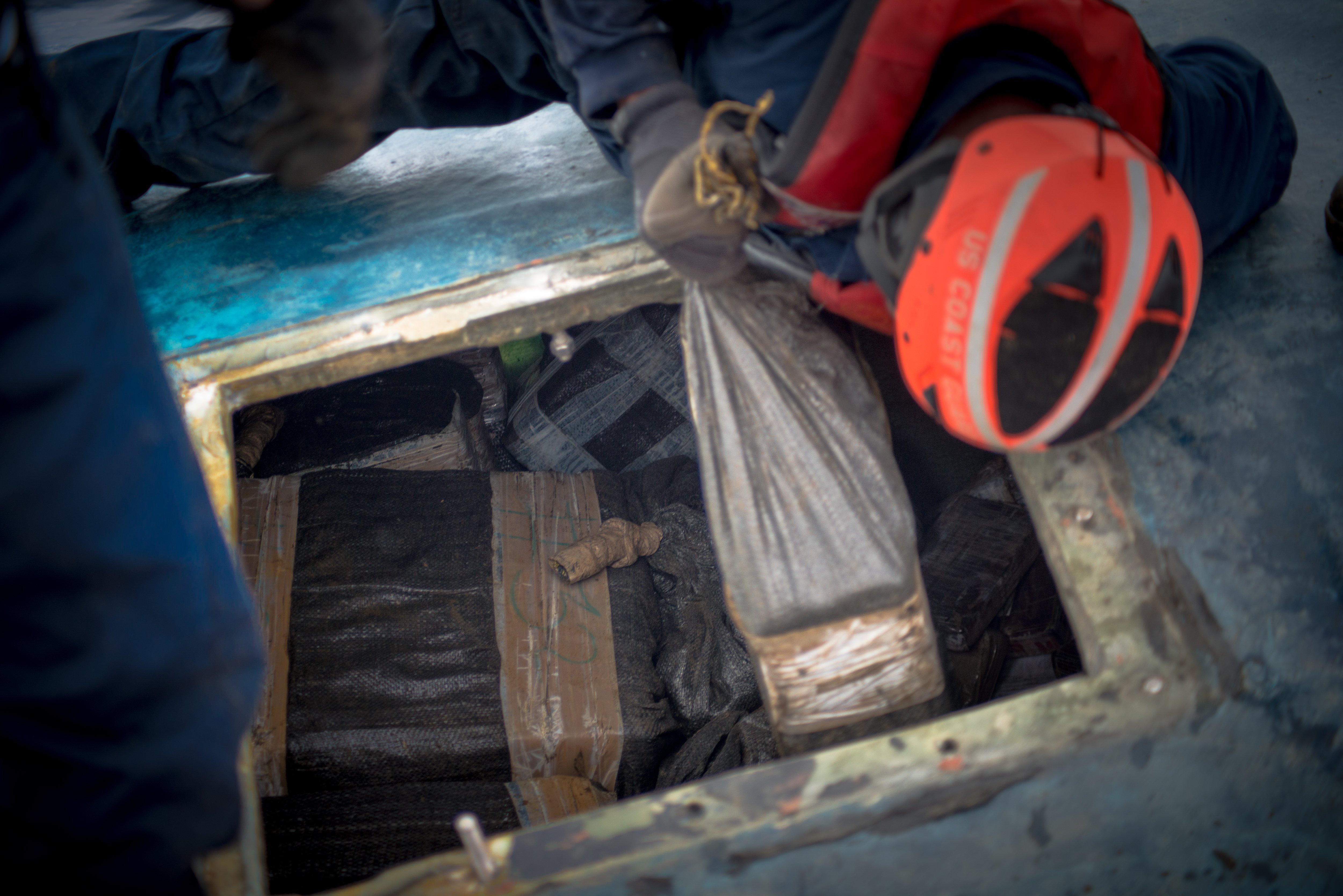 A Coast Guard Cutter Stratton boarding team seizes cocaine bales from a self-propelled semi-submersible interdicted in international waters off the coast of Central America, July 19, 2015. The Coast Guard recovered more than 6 tons of cocaine from the 40-foot vessel.