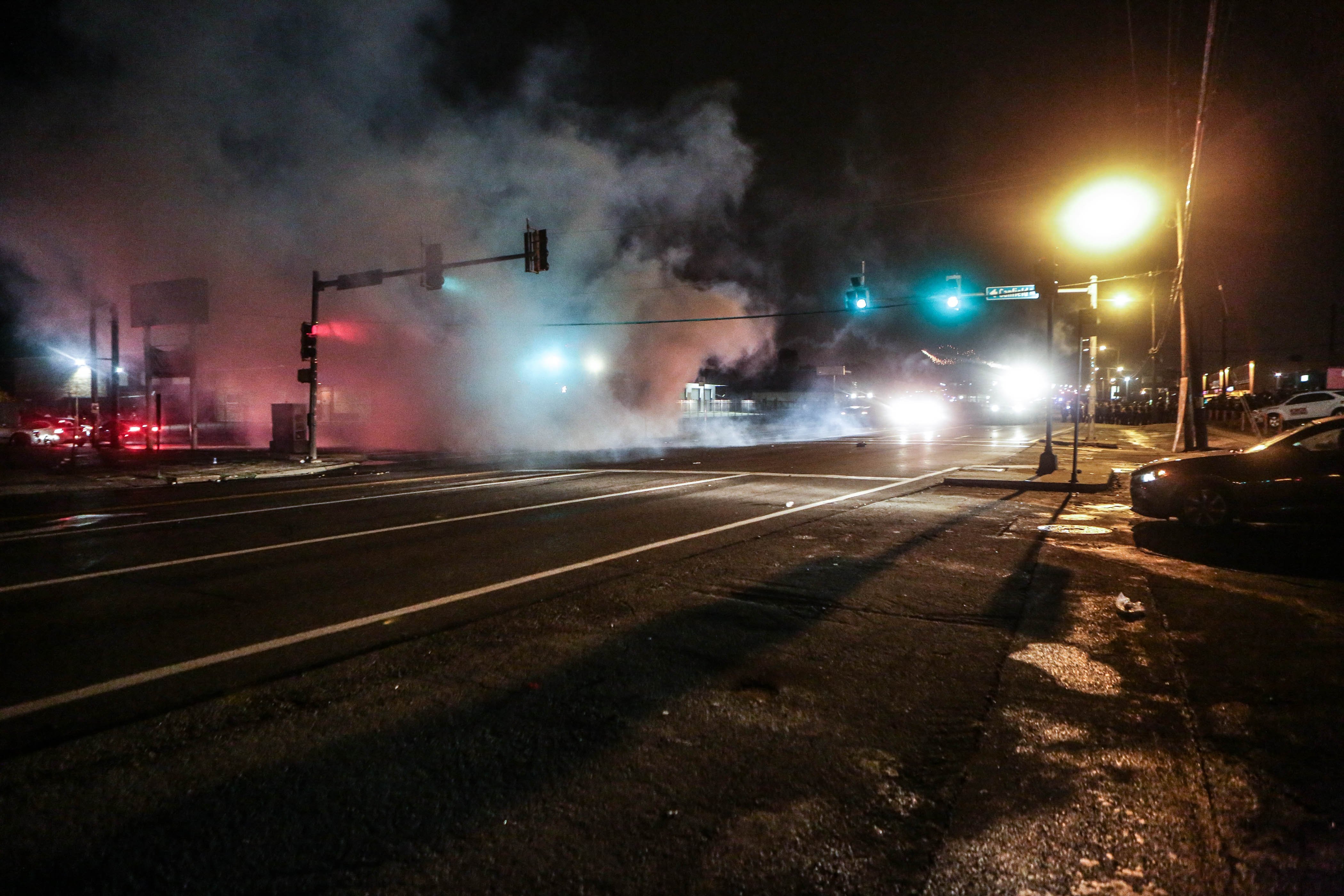 **Embargo: St. Louis, MO**

Clouds of smoke fill the street in Ferguson, Missouri on August 9, 2015, as gunfire marred a protest on the anniversary of the death of Michael Brown.