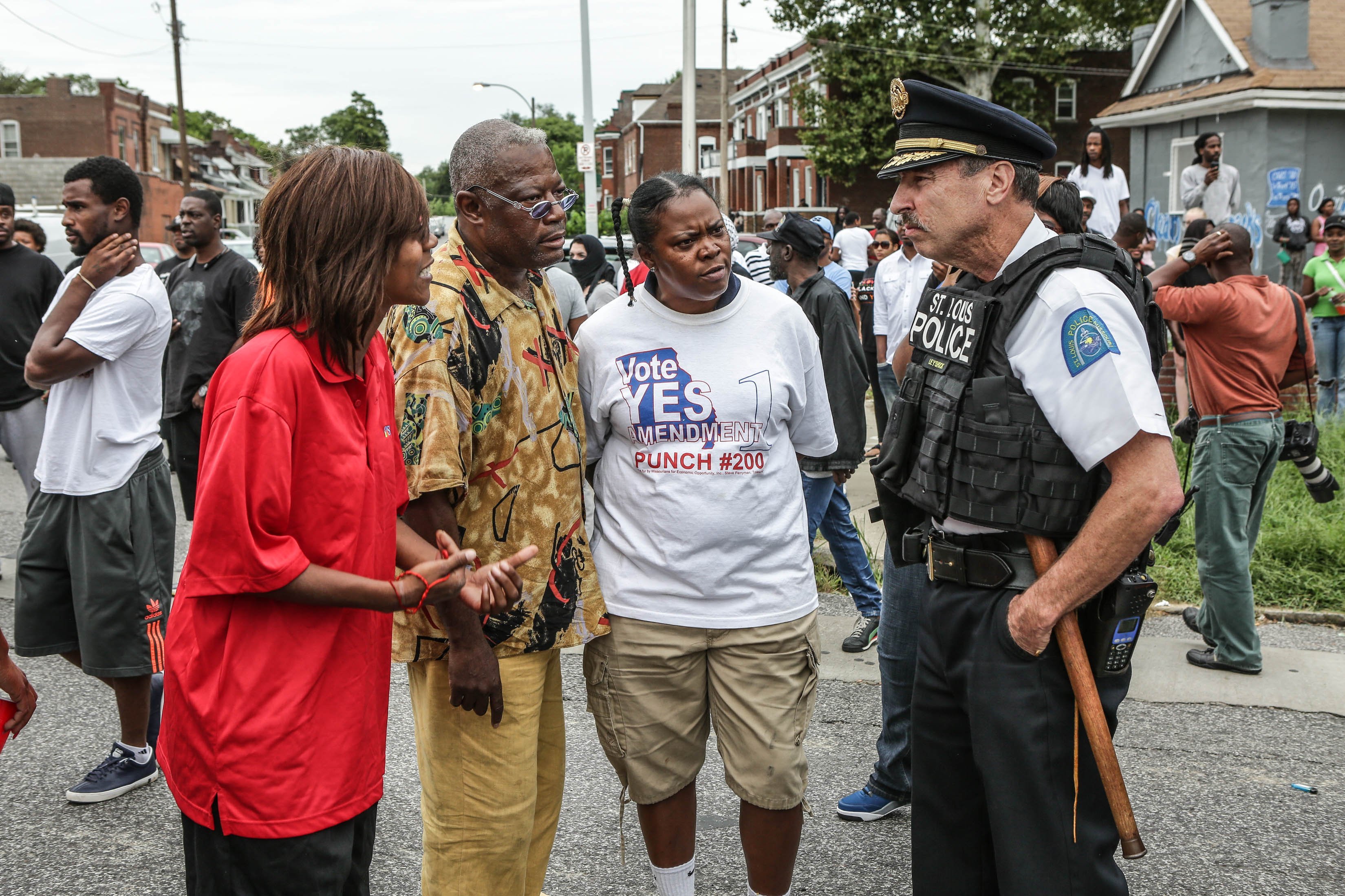 **Embargo: St. Louis, MO**

Residents speak with police in St. Louis, Missouri, on August 19, 2015, after police shoot and kill a suspect that allegedly pointed a gun at officers when they arrived to execute a search warrant.