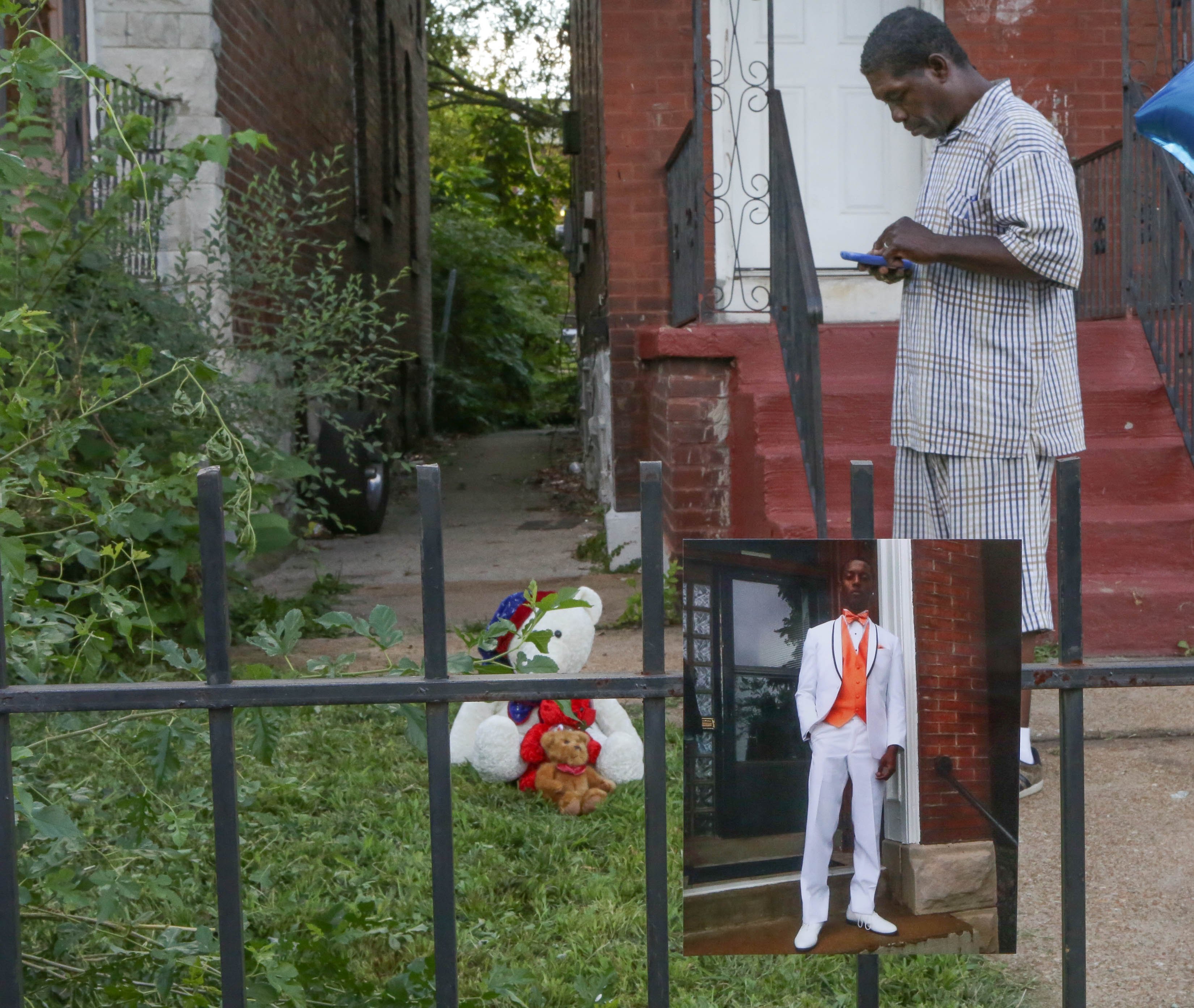 *Embargo: St. Louis, MO**

Father Dennis Ball-Bey stands in front of where police shot his son, Mansur Ball-Bey during his son's candel light vigil on Thursday, August 20, 2015 night. Mansur Ball-Bey was shot and killed by police after police say he pointa a gun at them. Protests took to the streets since then with police using tear gas to disperse demonstrators.