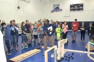 Penn State DuBois Assistant Professor of Engineering Daudi Waryoba introduces teams to the playing field they'll navigate their robots through during BEST. (Provided photo)