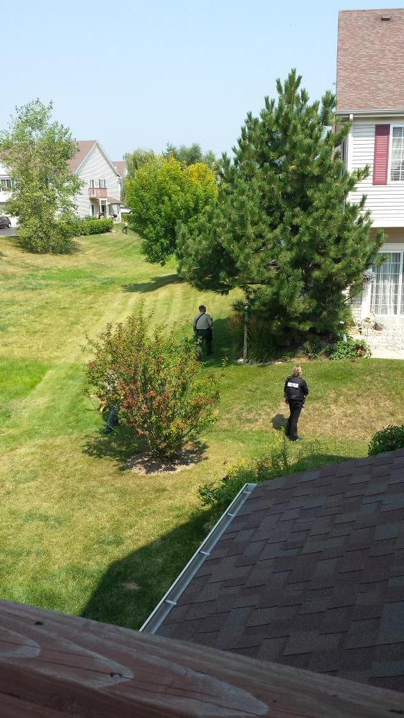 Police and additional agencies search for three suspects after a police officer was shot and killed in Fox Lake, Illinois on September 1, 2015. Officers took to the air in helicopters and searched the ground by foot looking for the suspects.